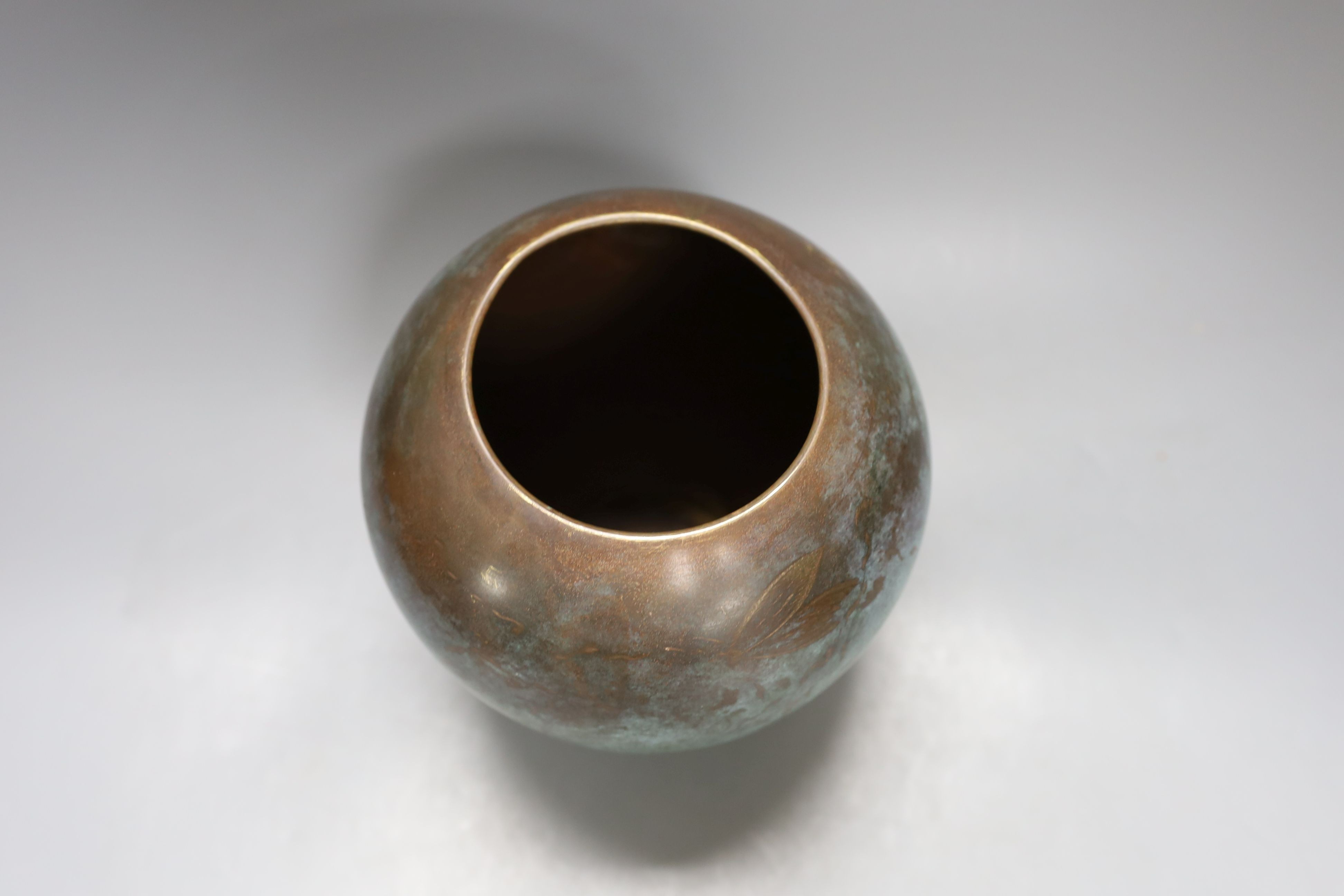 An Arts and Crafts planished copper mirror and a WMF Ikora vase